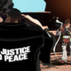 Guilty Gear's Nagoriyuki stands with his back to the viewer, "No Justice No Peace" emblazoned on his jacket, as Sol Badguy waits in the background.